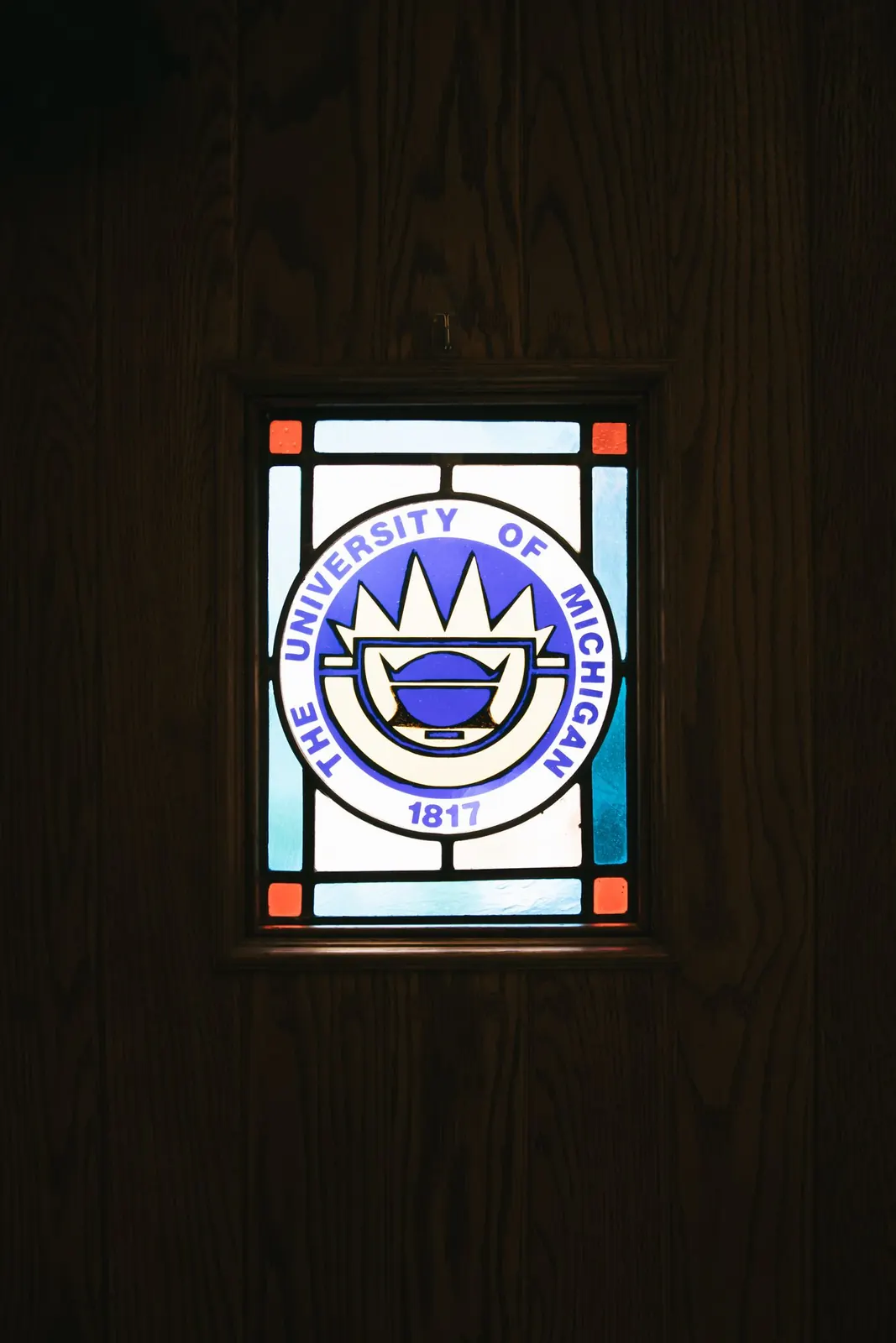 University of Michigan seal in chapel stained glass